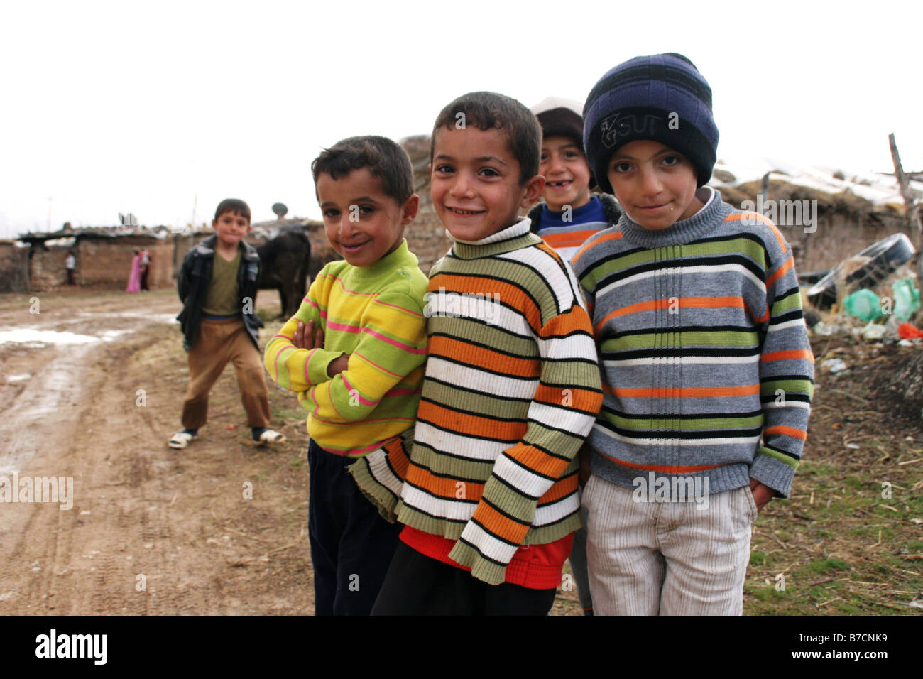 curious children in front of  mud huts in a small  kurdish village close to Amedi in northern Iraq near the Turkish border, Ira Stock Photo