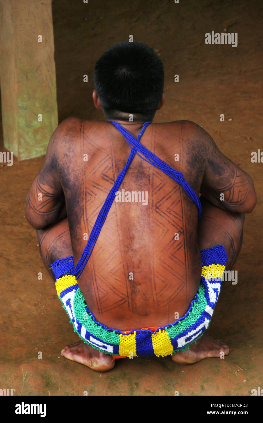 Embera Indian sitting with traditional clothing and body paint of jagua body ink  in Parar-Paru at the Chagres River, Panama, C Stock Photo