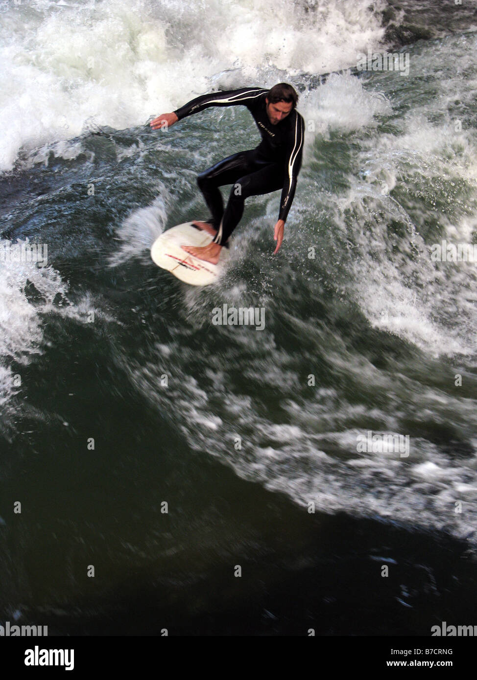 surfer on the so-called 'stehende Welle' (standing wave) of the Eisbach (branch of the river Isar) in the Englisch Garden, Germ Stock Photo