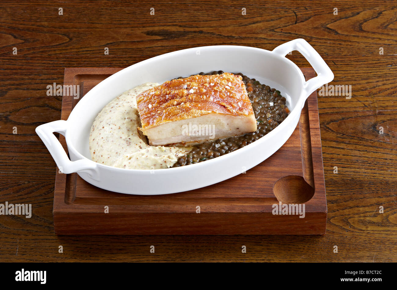 pork belly with mash and puy lentils Stock Photo