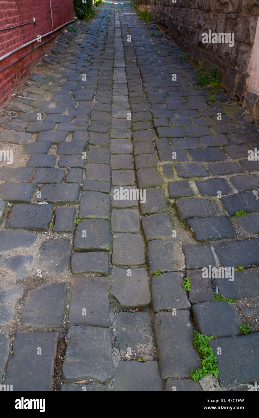 Old bluestone cobbles in Melbourne lanes showing drainage profile Stock Photo