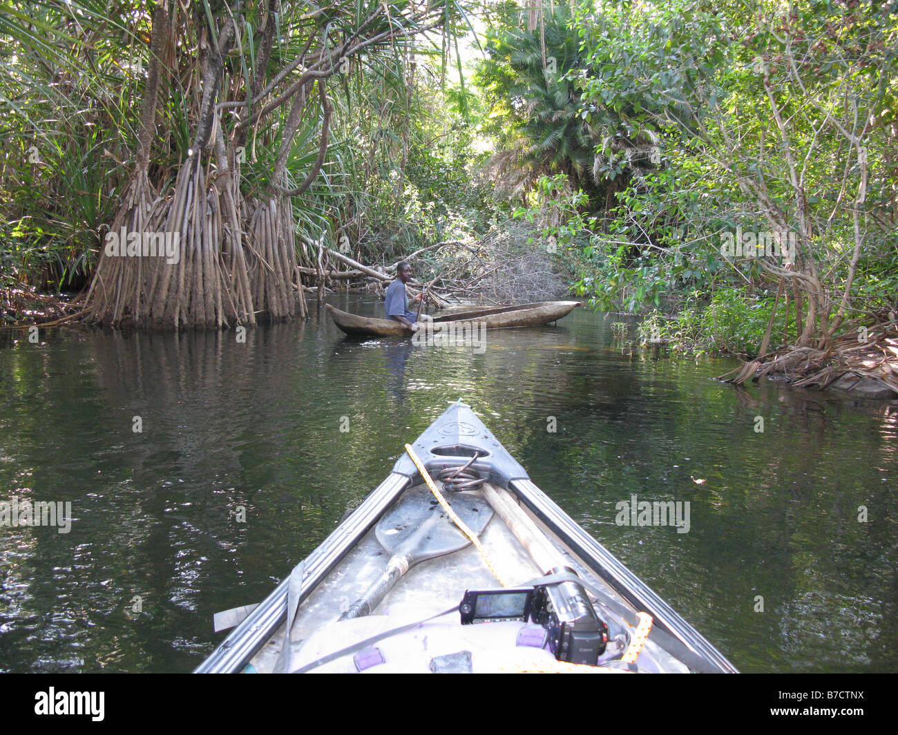 Canadian canoe prow with Bemba fisherman in dugout canoe on Luapula river close to Mambilima Falls Democratic Republic of Congo Stock Photo
