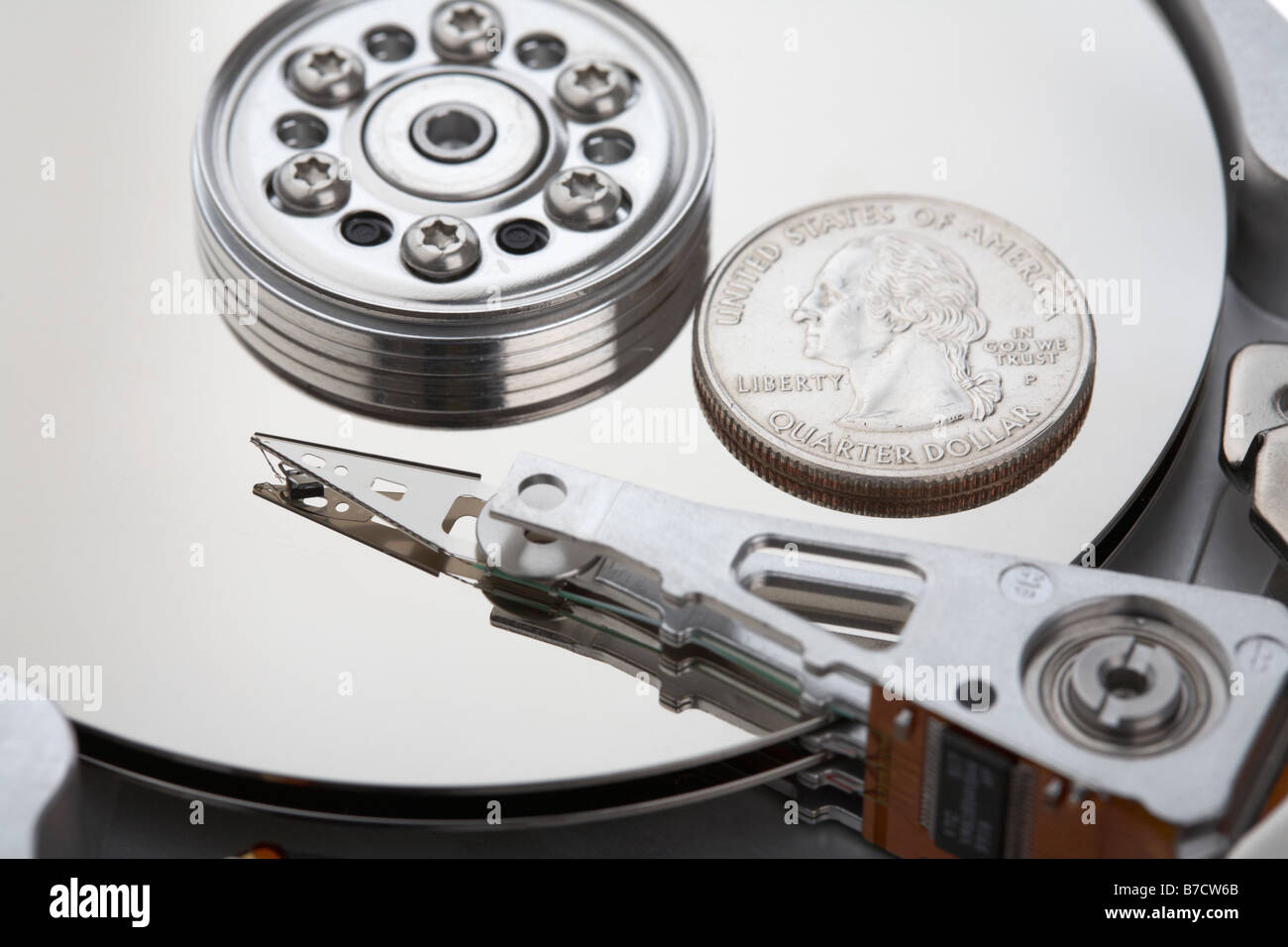 usa quarter dollar coin sitting on the platter of an open computer hard drive Stock Photo