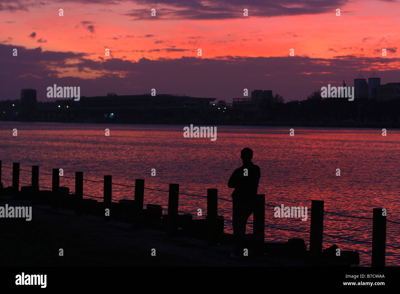 Silhouette of a man watching the sunset at Anping Harbor. Tainan, Taiwan Stock Photo