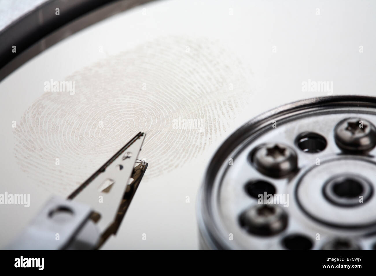 fingerprint left on the disc of an opened computer hard drive Stock Photo