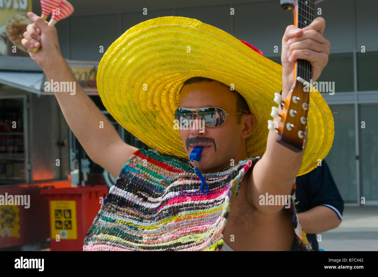 An Australian cricket fan wearing a sombrero and waving maracas arriving at the MCG for the annual Boxing Day test Stock Photo