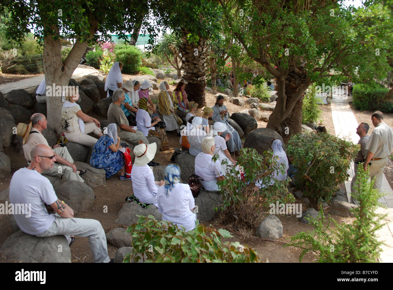 Pilgrim Group reading the Scriptures on Mount of Beatitudes in Galilee, Israel Stock Photo