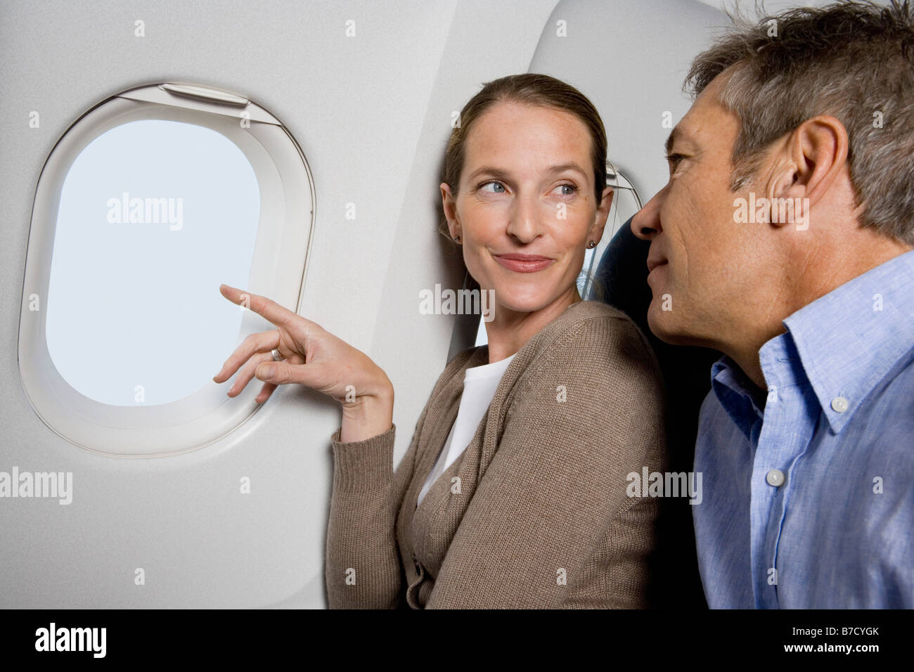 A couple looking out the window of a plane Stock Photo