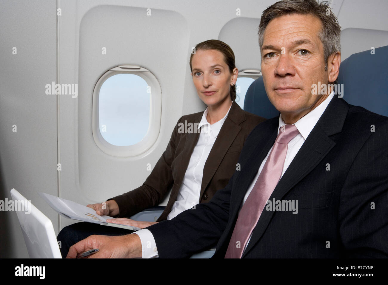 Two business people working on a plane Stock Photo Alamy