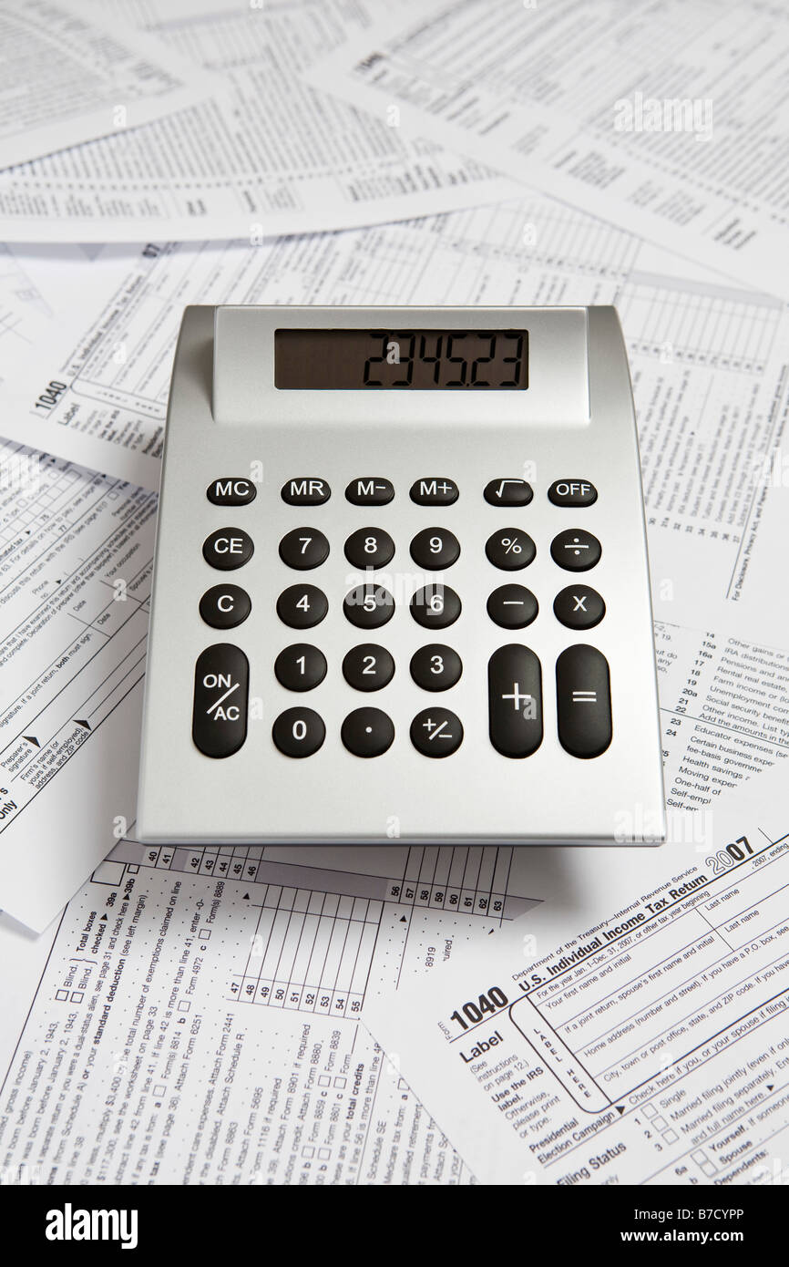 A calculator on top of tax return forms Stock Photo Alamy