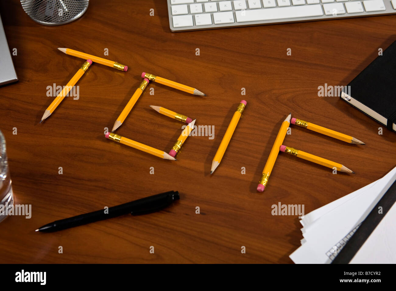 Pencils on a desk arranged to spell TGIF Stock Photo Alamy