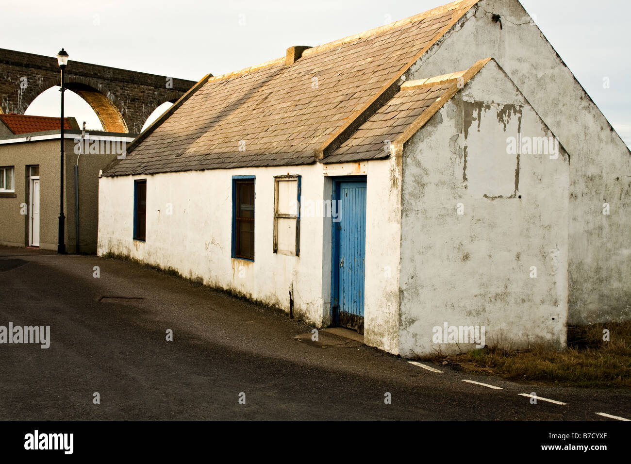 Old white cottage with a blue door in Cullen, Scotland Stock Photo Alamy
