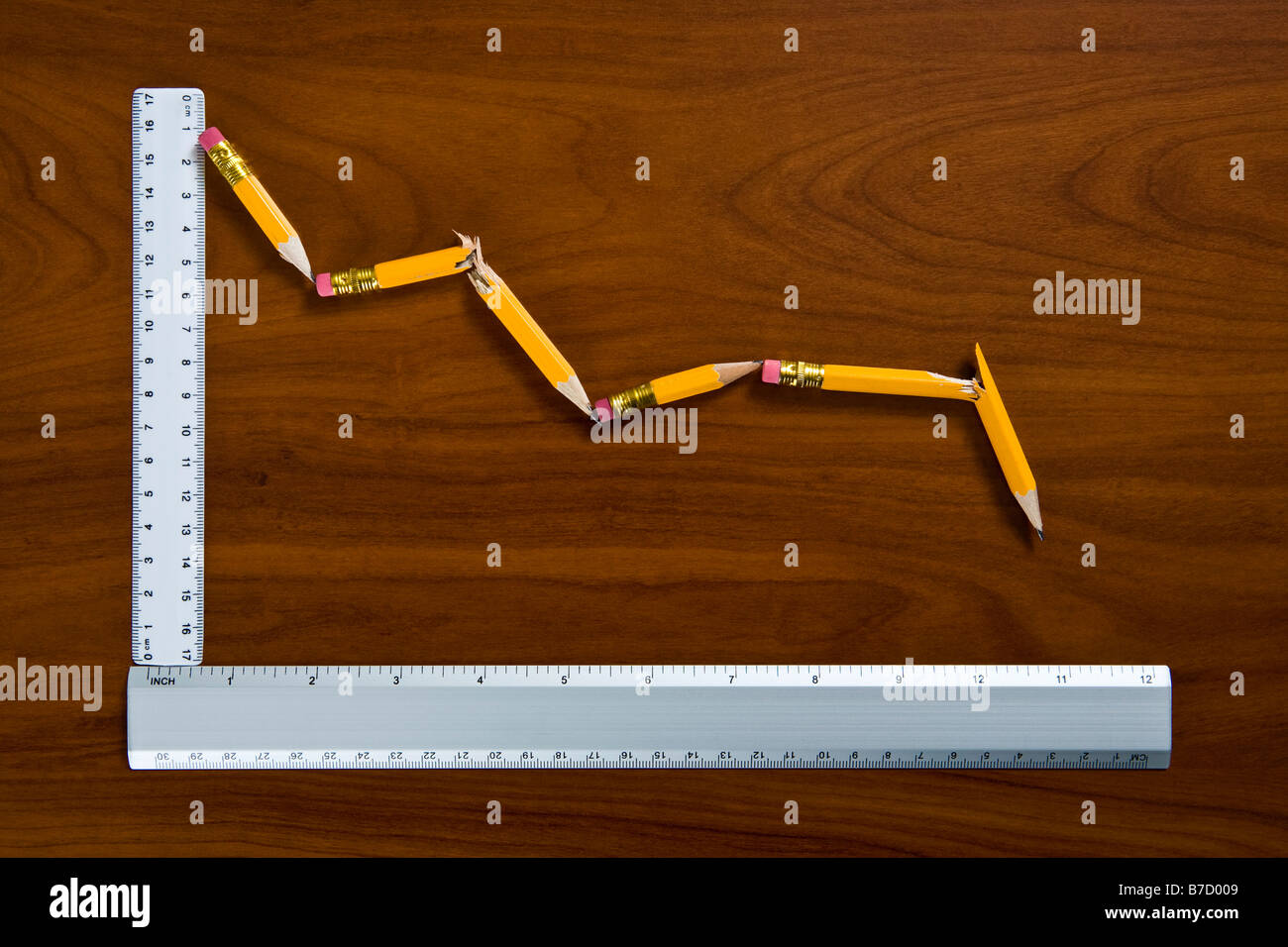 A line graph showing decline made from pencils and rulers Stock Photo