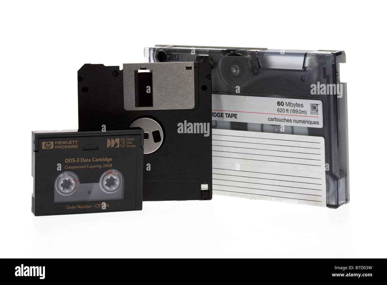 pile of old style mixed magnetic media tape cartridge dds dat tapes and floppy disc on a white background Stock Photo