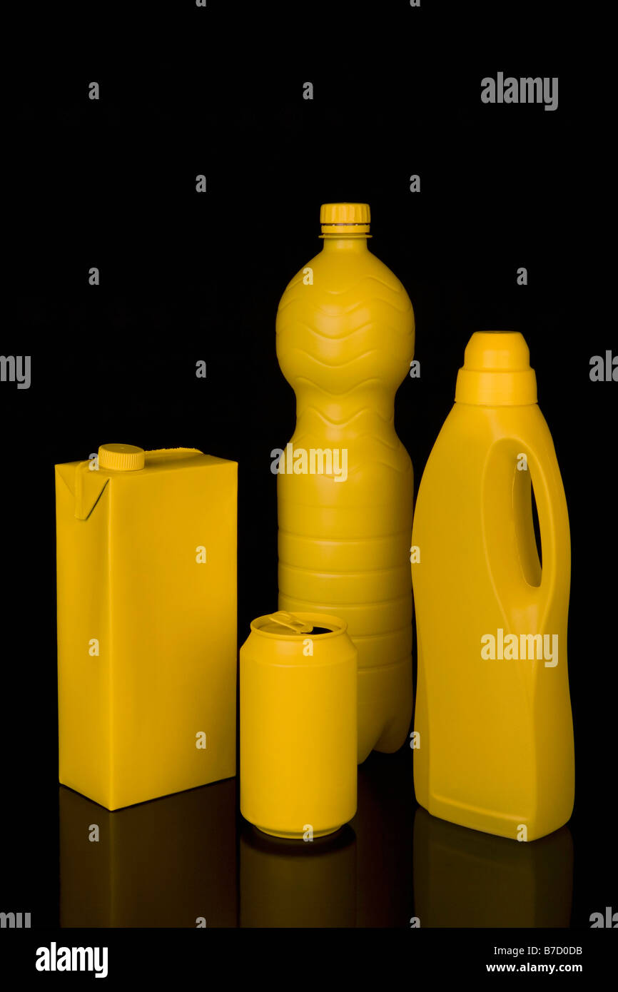 A milk carton, soda can, water bottle and laundry detergent bottle painted yellow Stock Photo