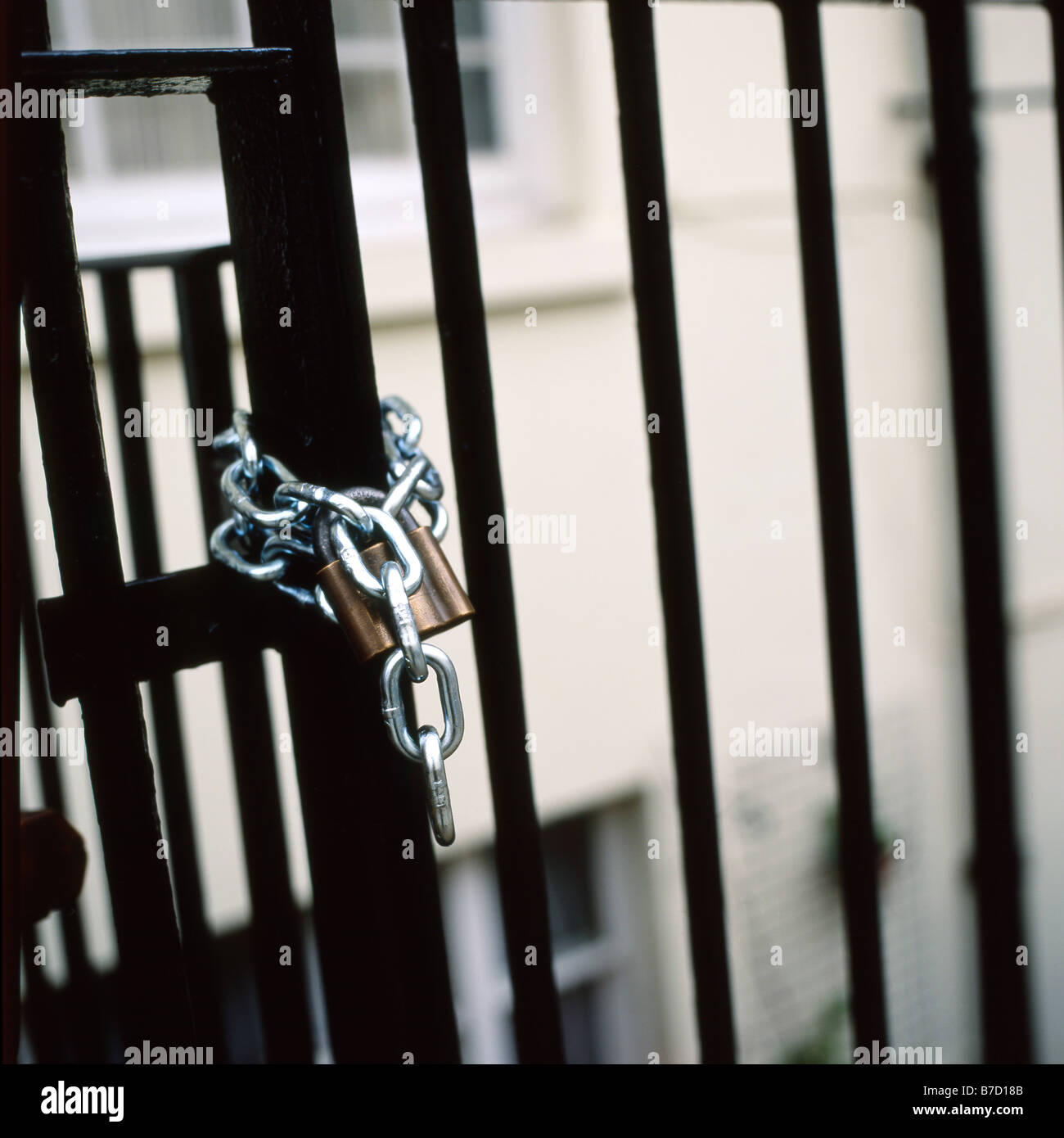 Chain on a black iron gate London England UK Stock Photo