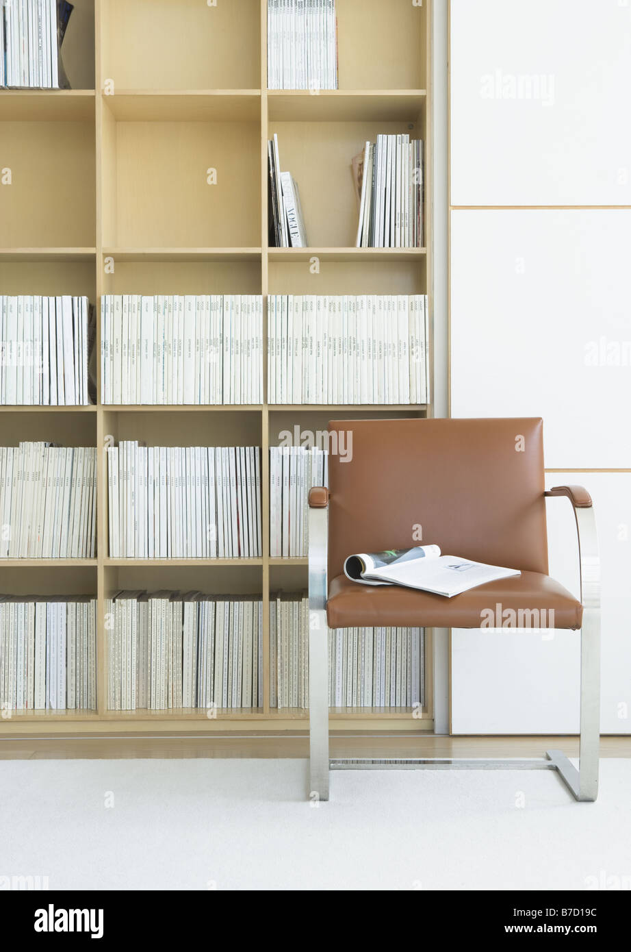 Bookshelf and chair Stock Photo - Alamy