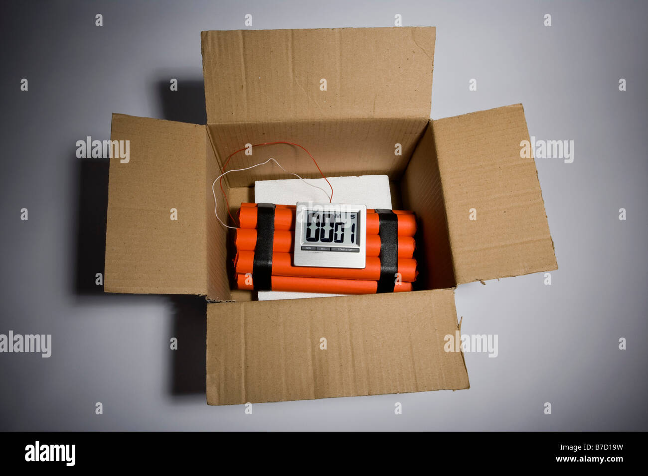 A dynamite time bomb in a cardboard box with 1 second left on the timer Stock Photo