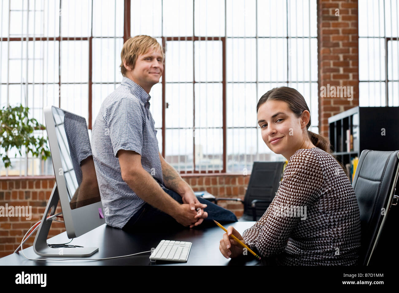 A woman and a man in an office Stock Photo - Alamy