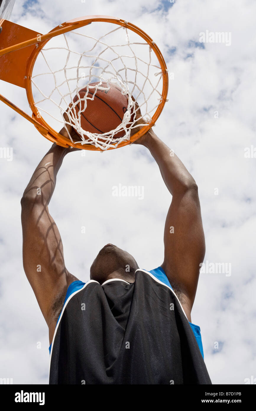 A basketball player preparing to make a slam dunk Stock Photo