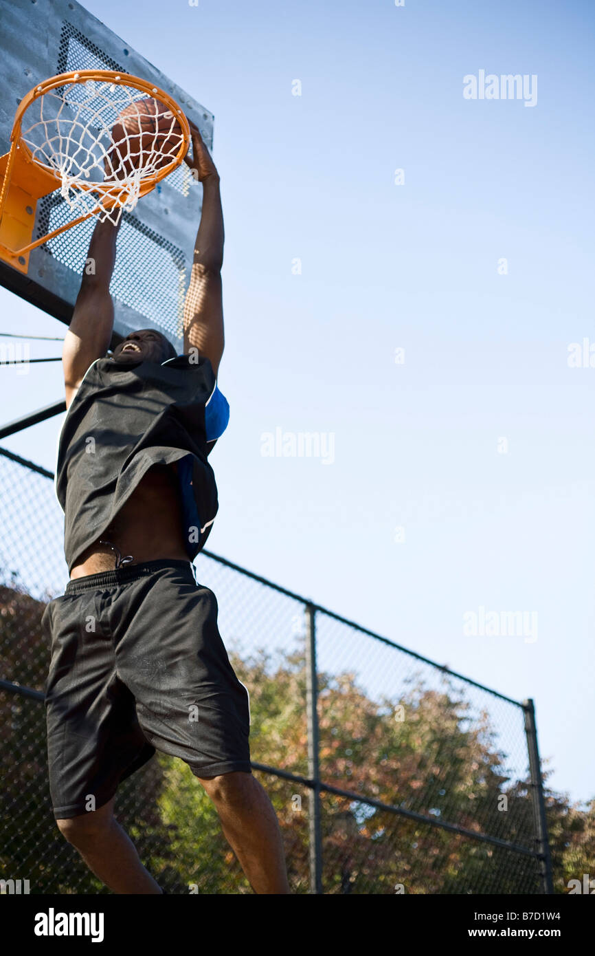 A basketball player making a slam dunk Stock Photo