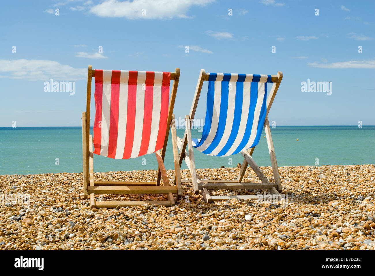 Two empty deck chairs on Brighton beach Stock Photo - Alamy