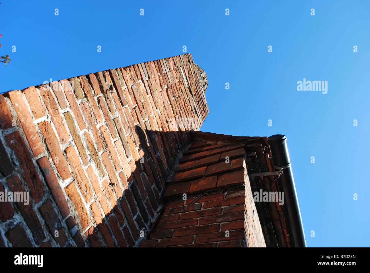 Tall chimney against a bright blue sky Stock Photo - Alamy