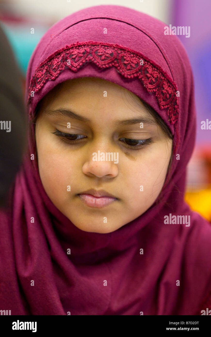 A Bangladeshi girl taking part in a graffiti art workshop in a primary school in tower Hamlets, East London. Stock Photo