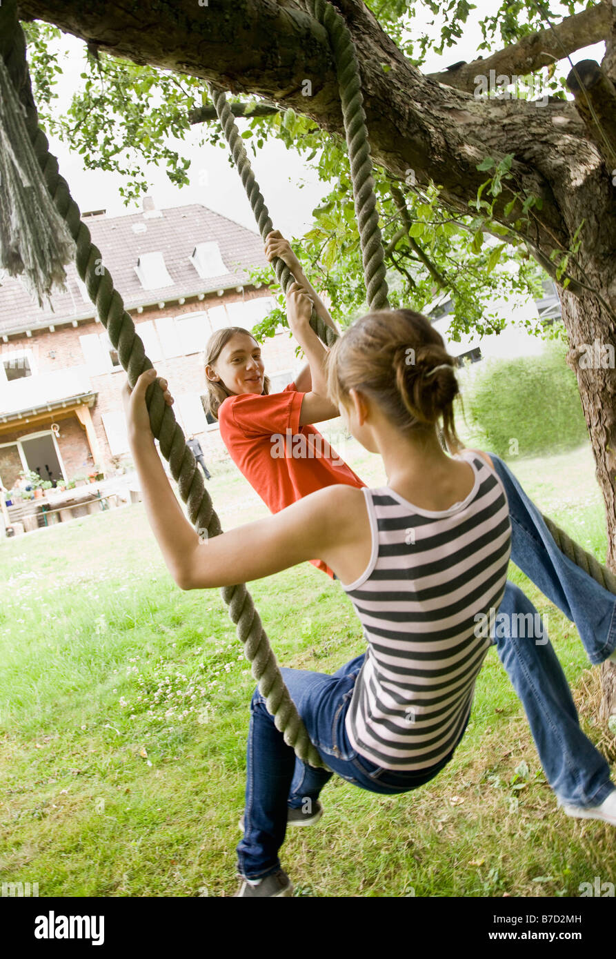 Young girl and boy on a tree swing Stock Photo Alamy