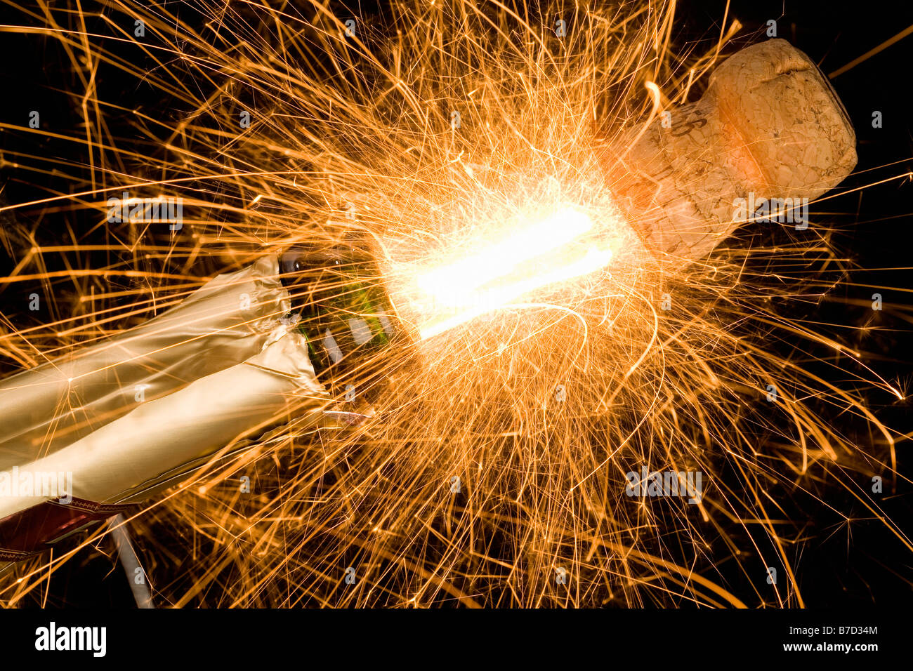 A champagne bottle opening with fireworks coming out Stock Photo