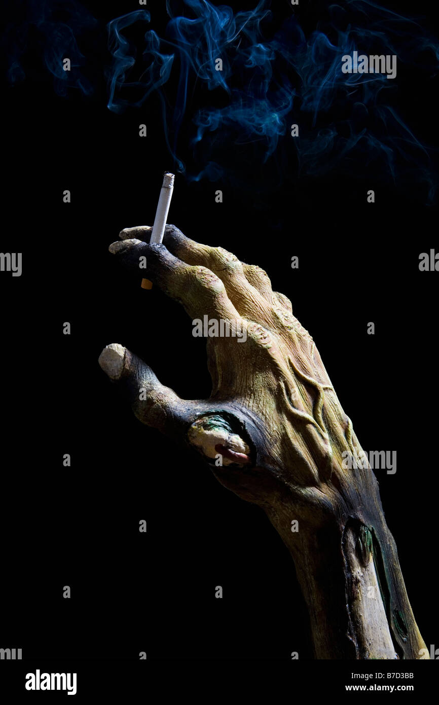 Monster's hand holding a cigarette Stock Photo