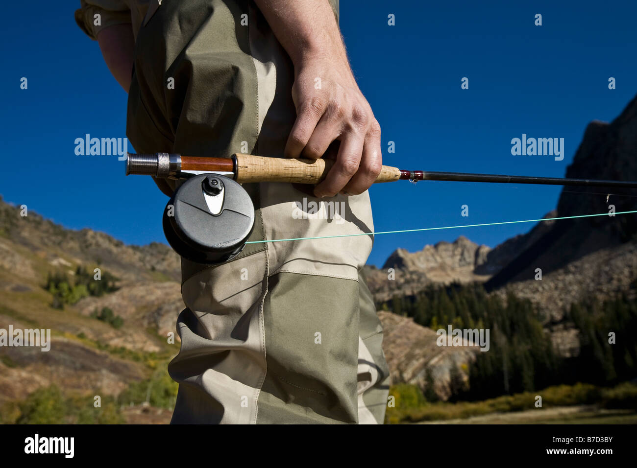 Midsection of a man holding a fly rod Stock Photo