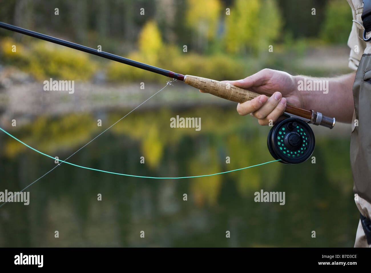 Detail of a man holding a fly rod Stock Photo