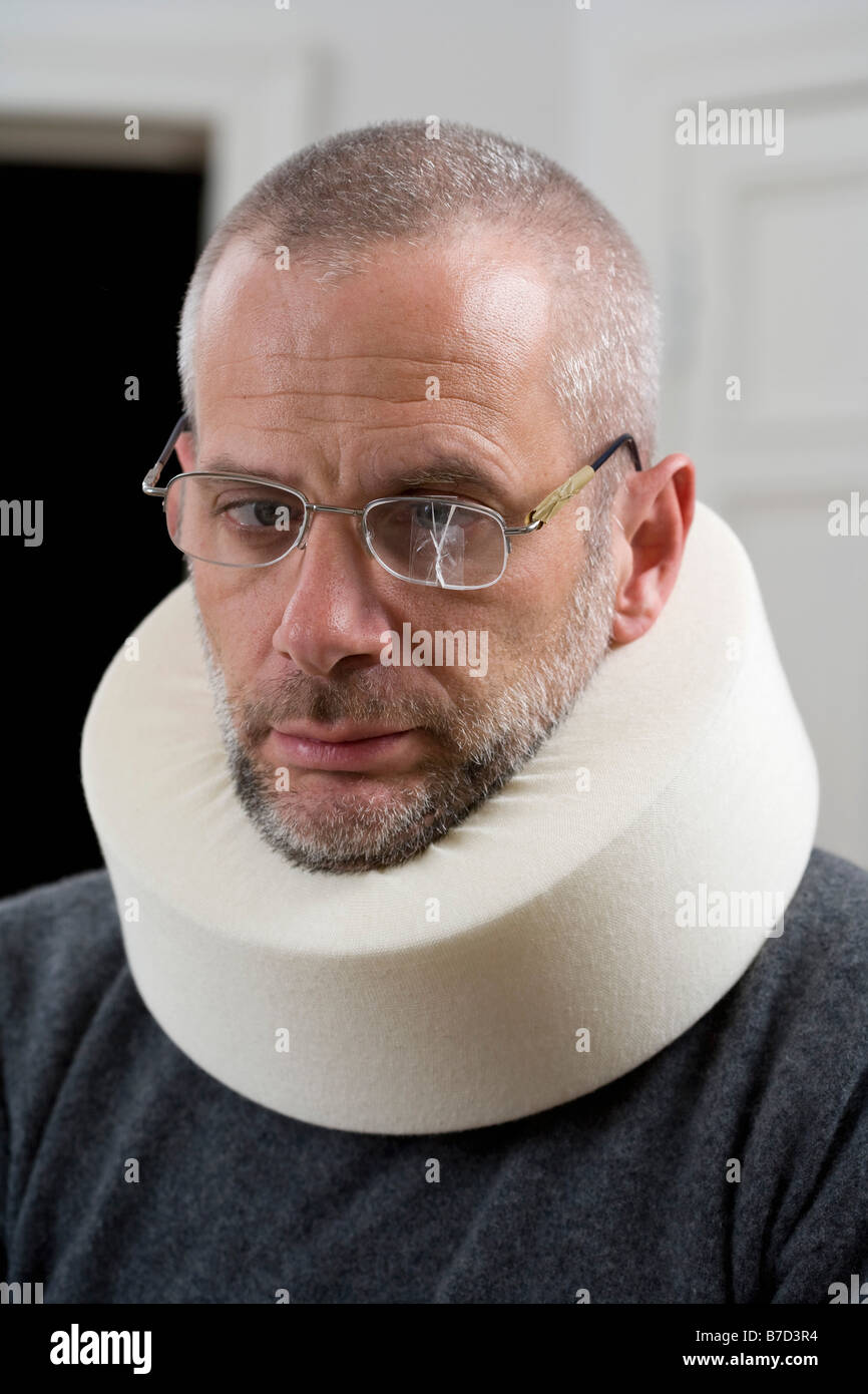 A man wearing a neck brace and cracked glasses Stock Photo