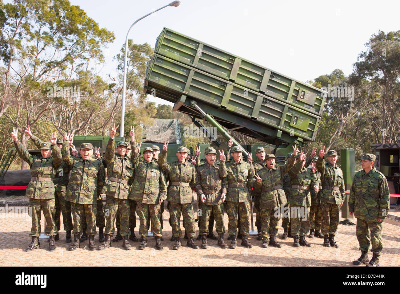 Group Portrait Of Soldiers Standing In Front Of A Tien Kung SAM, Sky Bow 1, Surface to Air Missile Launcher, Taichung, Taiwan Stock Photo