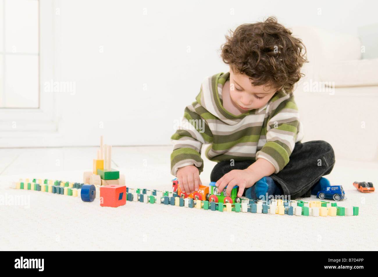 A boy playing with his toys Stock Photo - Alamy