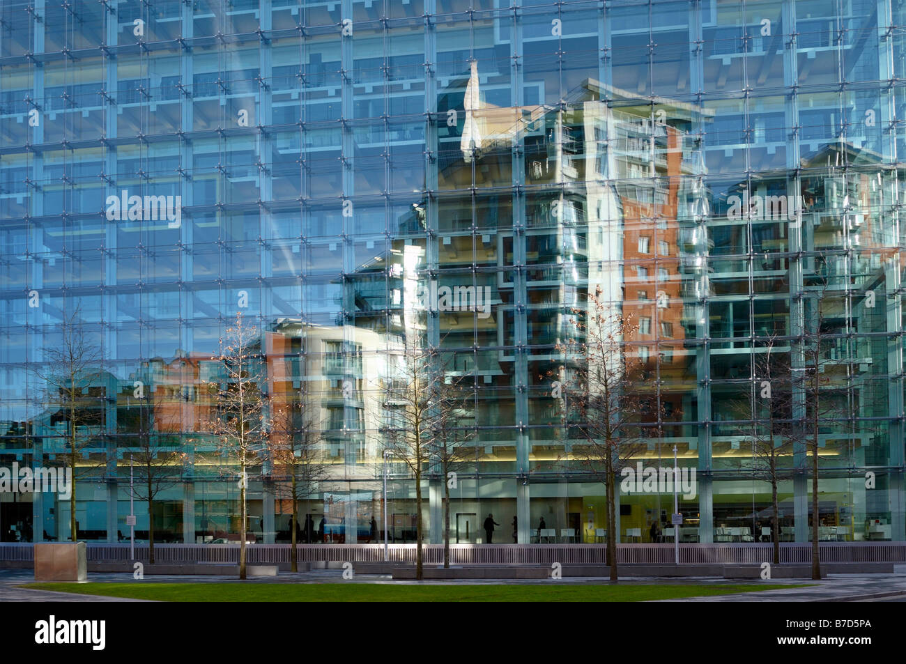 reflections in the glass panels of the civil justice center located within the spinningfields area of Manchester city center Stock Photo