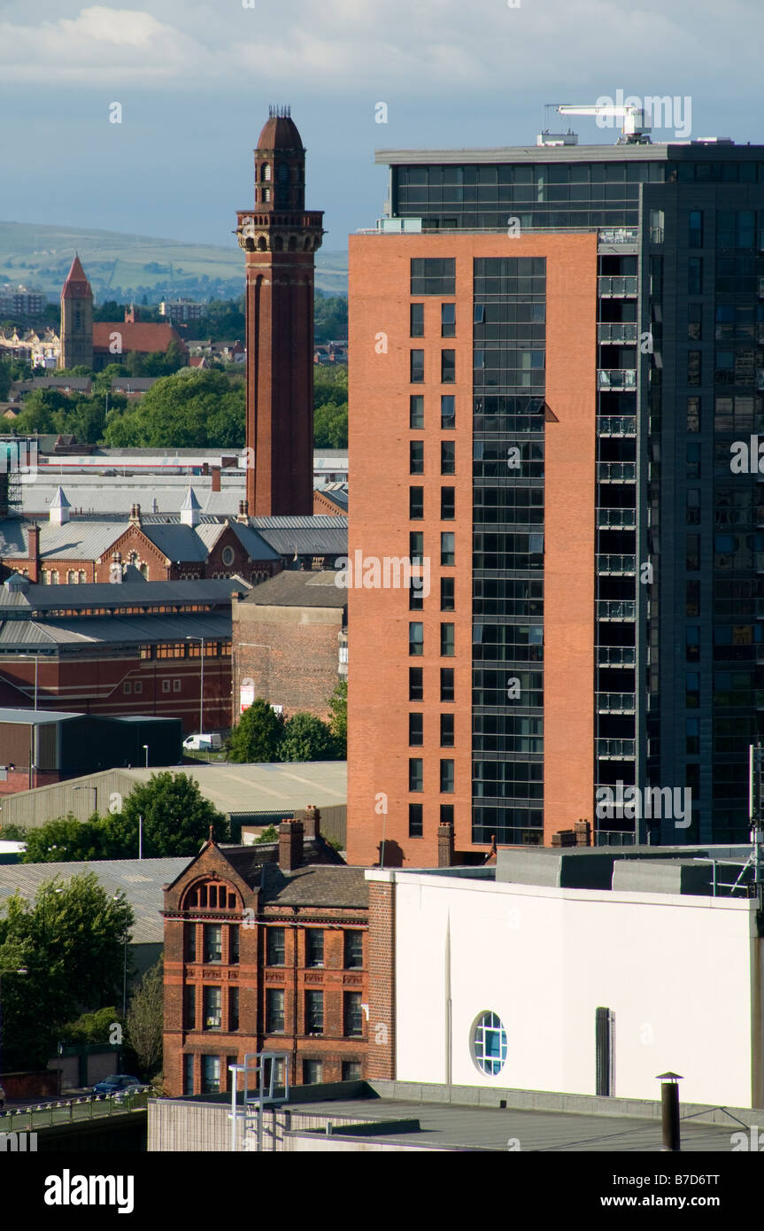 High level view of an apartment block with the tower of Strangeways Prison in the distance, Manchester, England, UK Stock Photo