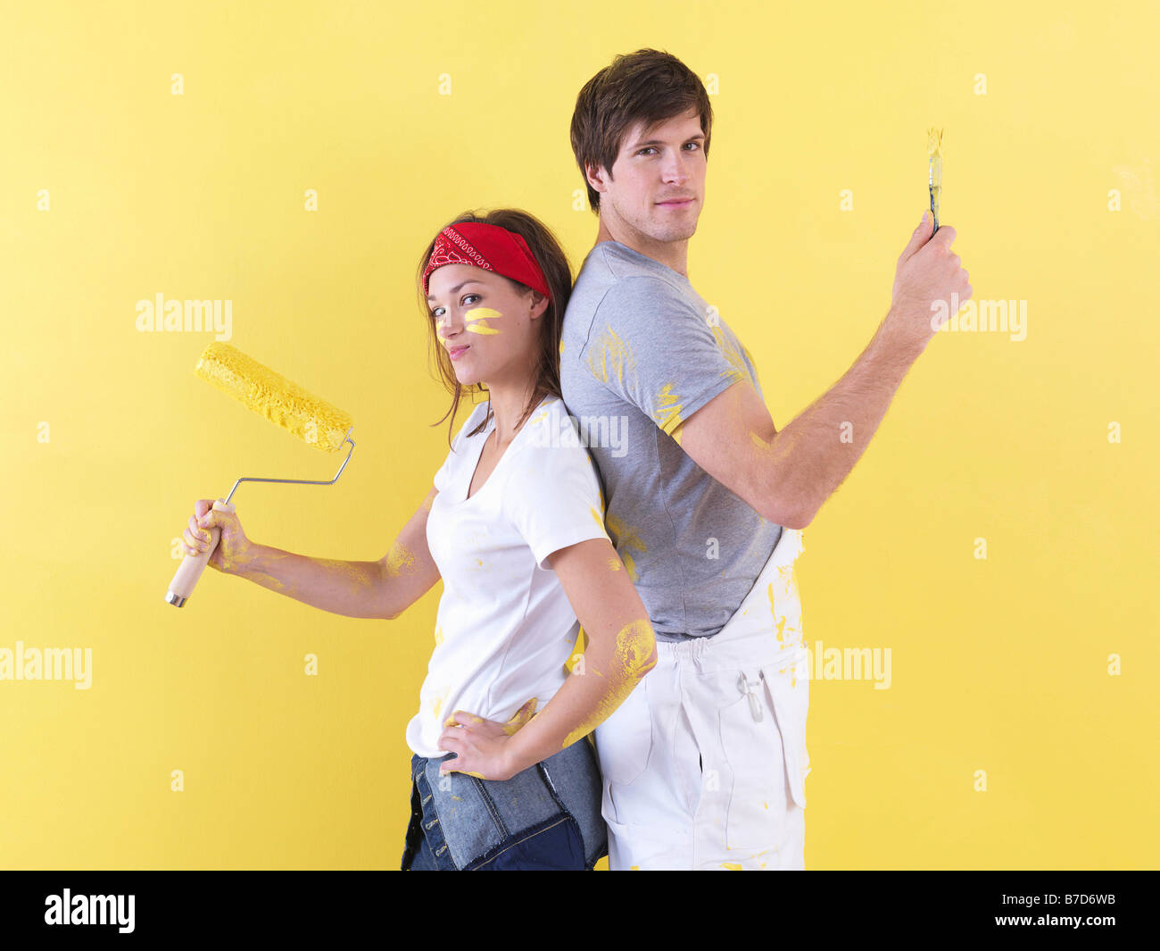 Couple posing in front of wall. Stock Photo