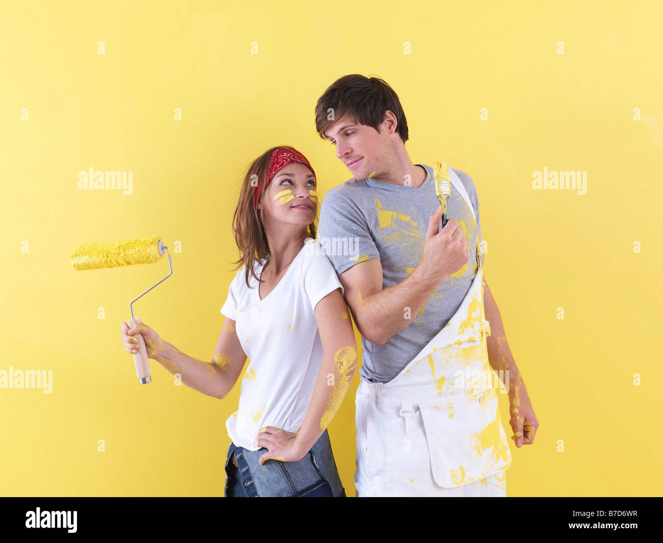 Couple posing in front of wall. Stock Photo