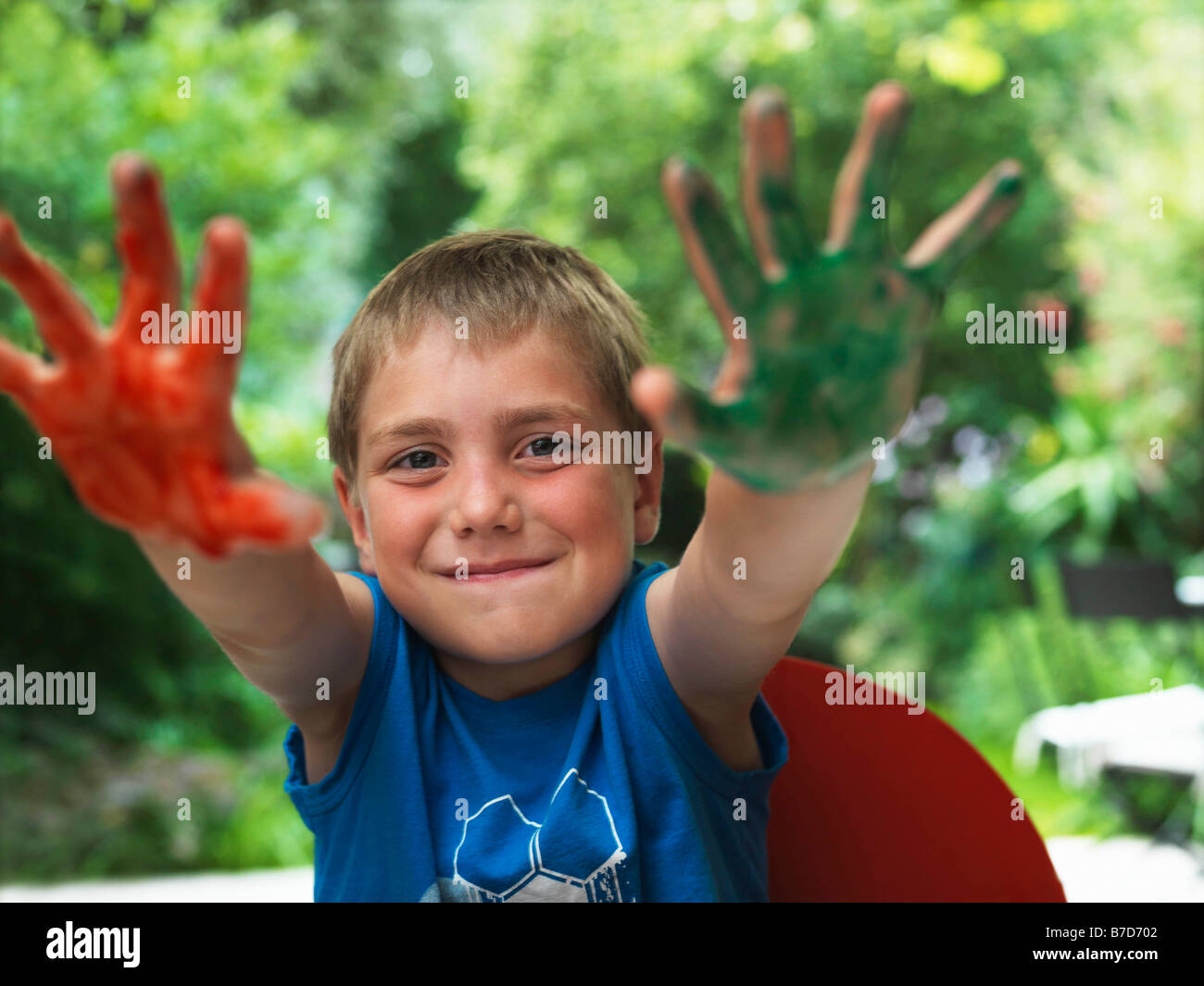 Boy showing paint on hands Stock Photo