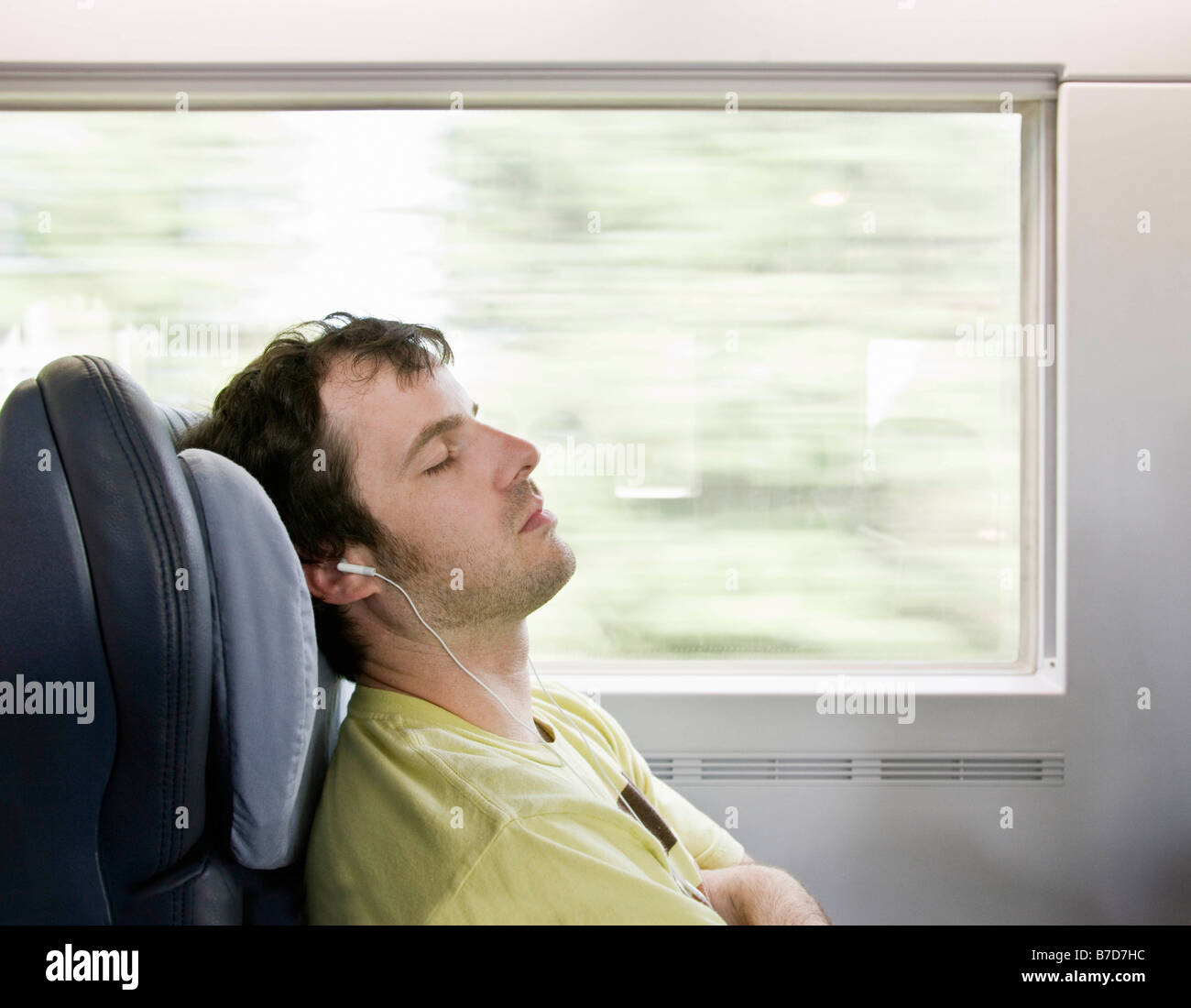 Man sleeping on moving train Stock Photo