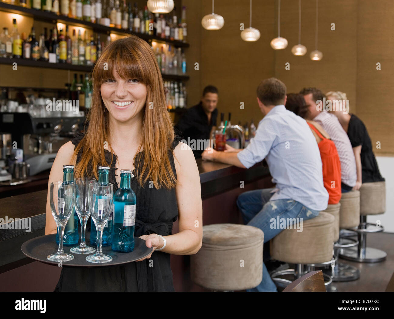 Waitress holding tray of drinks Stock Photo Alamy