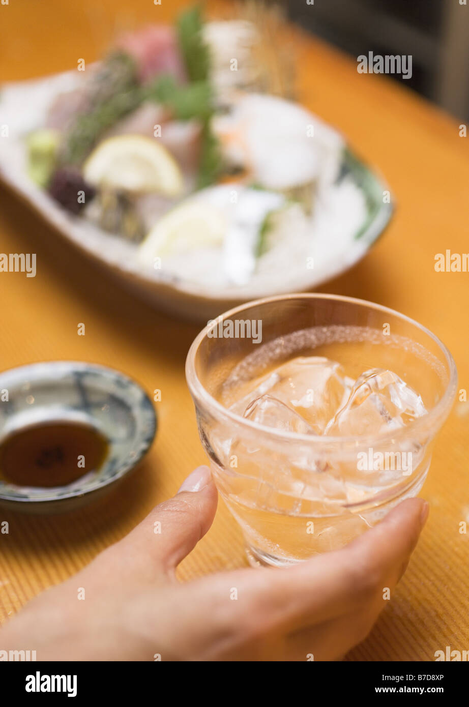 Distilled Spirits Beside Sashimi Stock Photo