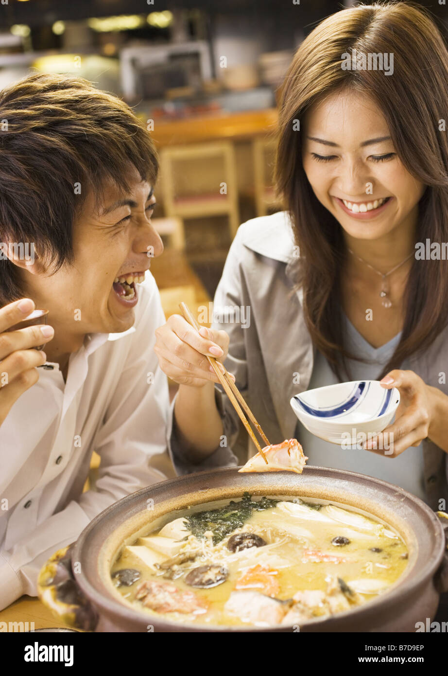 Couple Eating Japanese Style Chowder Stock Photo