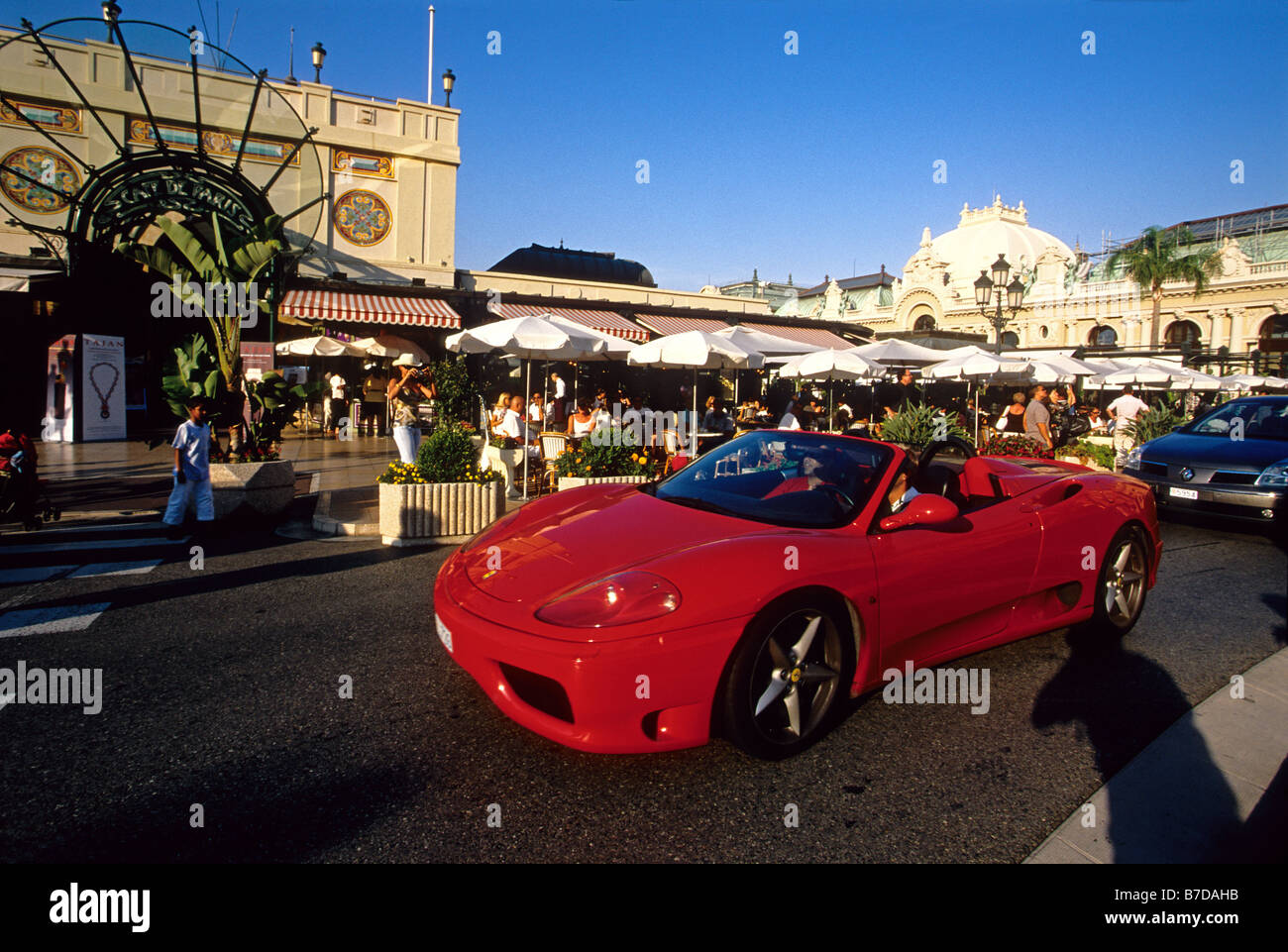 Luxury car showing up along the Cafe de Paris in the Casino square of Monaco Stock Photo