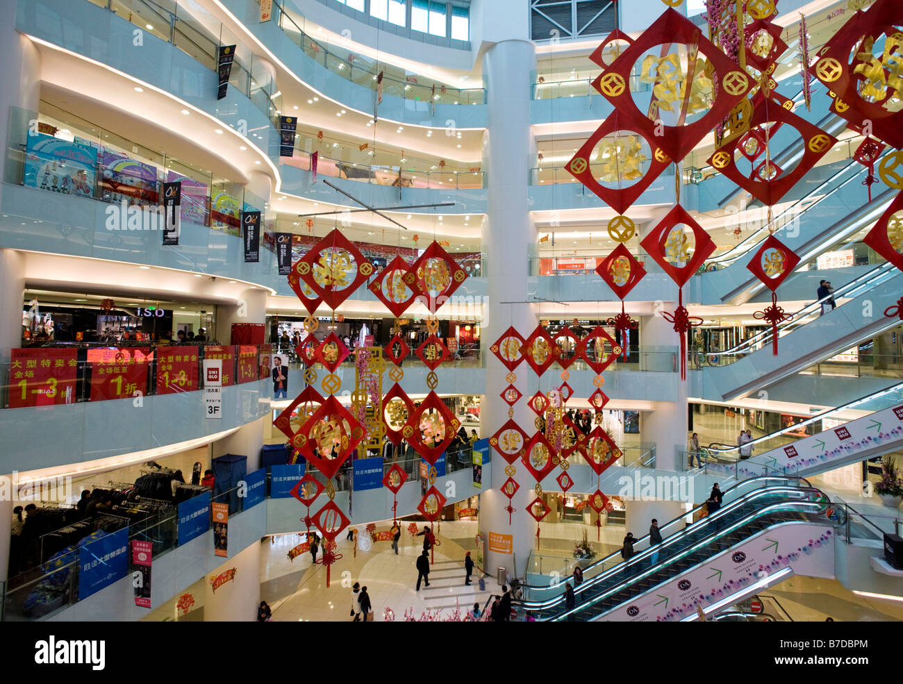 Interior atrium of modern APM shopping mall on Wangfujing street in central Beijing Stock Photo