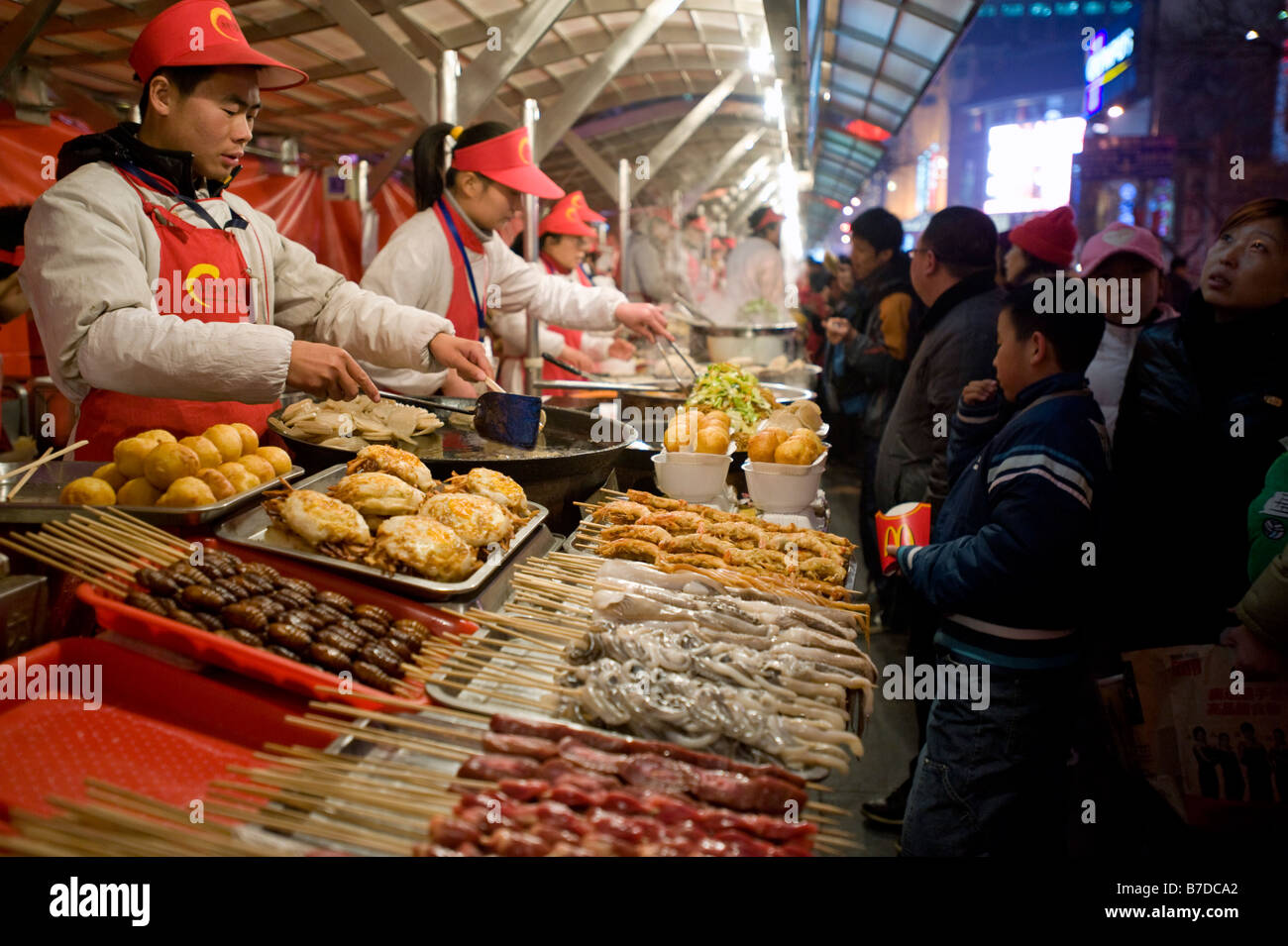 Vendors at a food stall in Donghuamen street night food market in Beijing 2009 Stock Photo