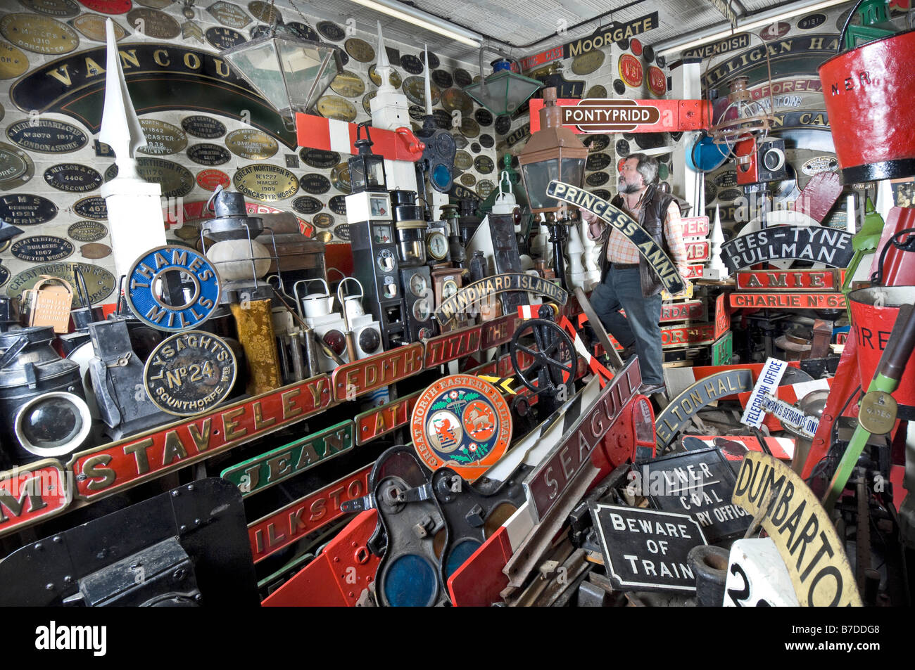 Doncaster Grammar School Railway Museum curator Pete Sargieson arranges steam locomotive nameplates. Stock Photo