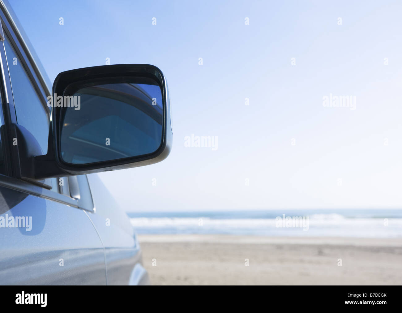 Wing mirror on a beach Stock Photo